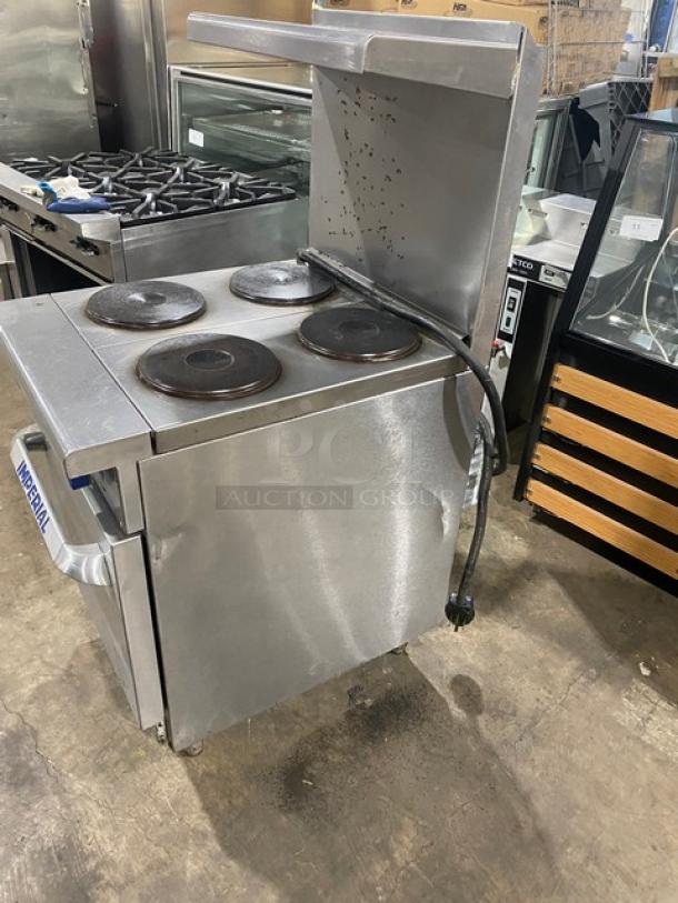 Imperial commercial stainless steel 4-burner hot plate range/oven combo with backsplash, overhead salamander shelf, and wire oven rack.