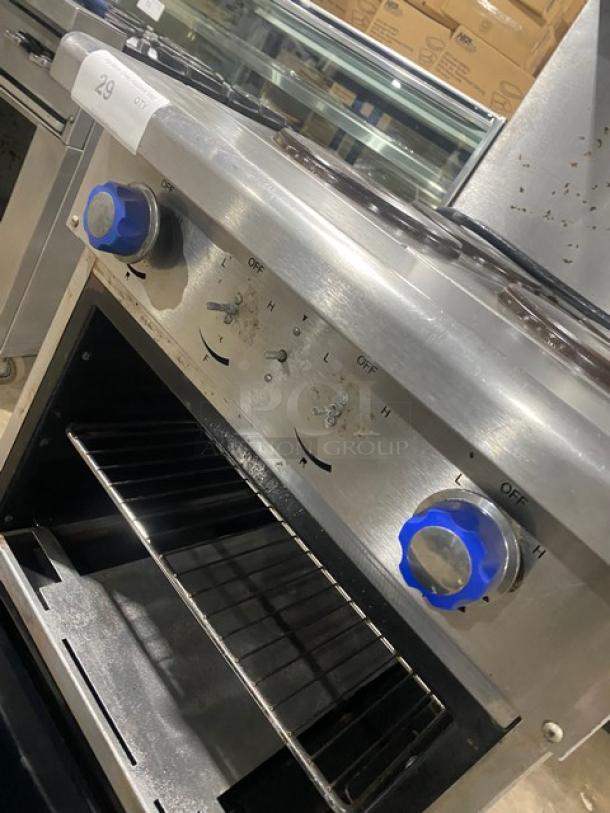 Imperial stainless steel 4-burner electric range/oven with backsplash, overhead salamander shelf, wire oven rack, and control knobs.