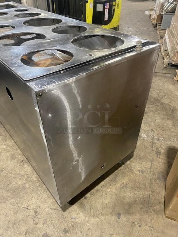Commercial stainless steel cabinet with double shelf base, drop-in adapter plate, and drain hole on legs. Good condition.