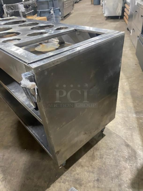Commercial stainless steel cabinet, double shelf with drop-in adapter plate, drain hole, and legs; good condition.