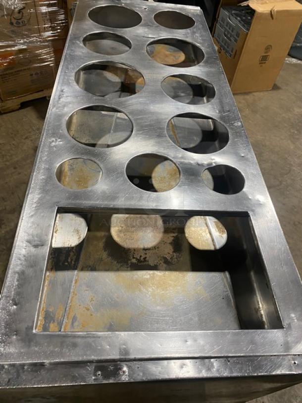 Commercial stainless steel double shelf base cabinet with drop-in adapter plate. Features drain hole and sturdy legs.
