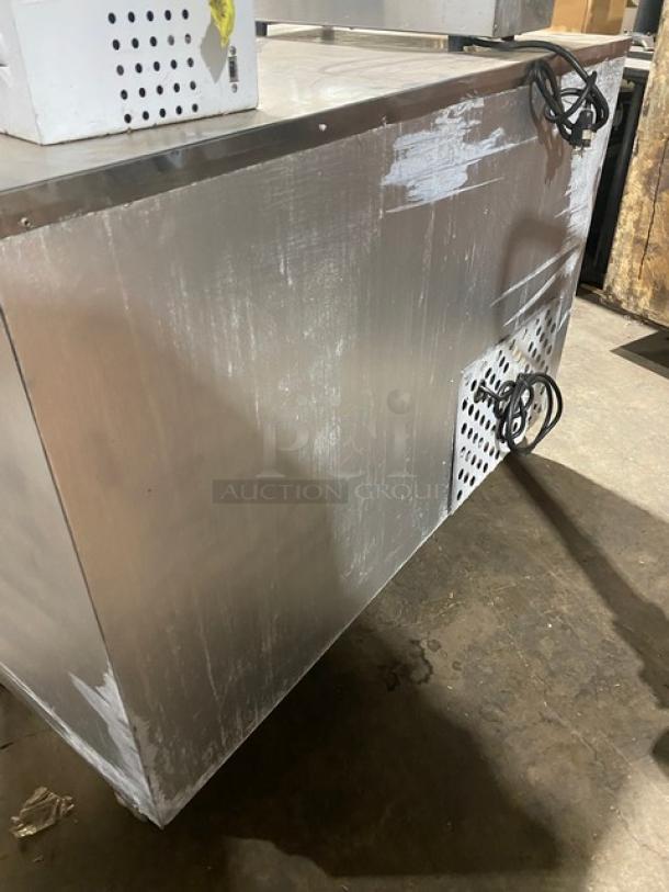 Leader LB48SC stainless steel 2-door lowboy refrigerator with chrome-plated wire rack, on casters, showing side view and wear.