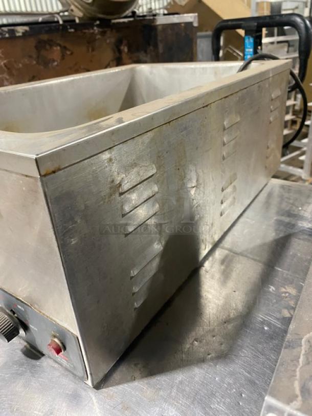 Nemco stainless steel electric countertop food warmer, single well, 120V, shows signs of wear, knobs and power cord visible.