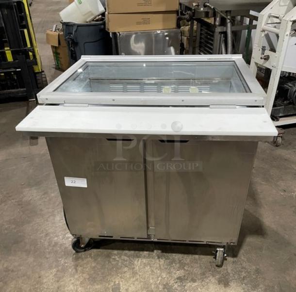 Beverage-Air stainless steel 2-door refrigerated prep table with glass top and cutting board. Model SPE36HC-15M-STL on casters.