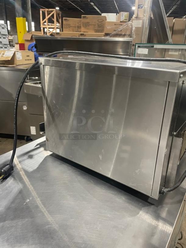 Sitaras PerfecToast Series 28LT commercial stainless steel conveyor toaster, electric, on legs, shown in a warehouse setting.