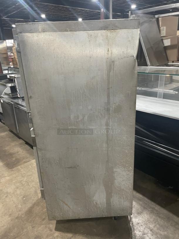 Metro Flavor Hold C199H1N single section heated cabinet, stainless steel, visible wear, on casters for mobility.