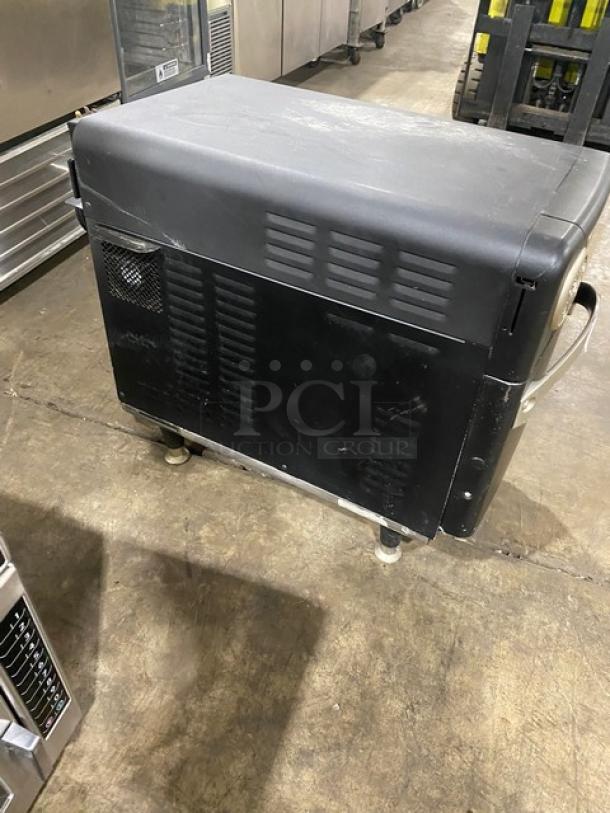 TurboChef NGO commercial rapid cook oven, black, ventless, electric-powered, countertop model with crank bar, on legs.