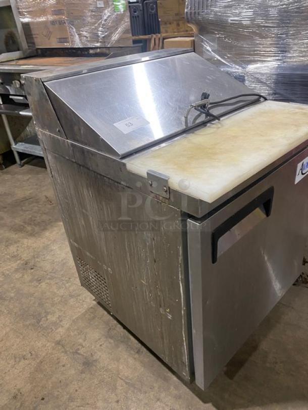 Avantco commercial stainless steel refrigerated prep table with cutting board and poly-coated wire rack, on casters.