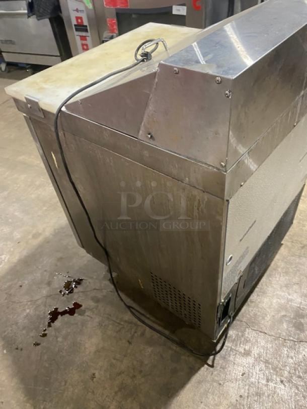 Avantco stainless steel refrigerated bain marie prep table with cutting board, poly-coated wire rack, and casters; shows used condition.