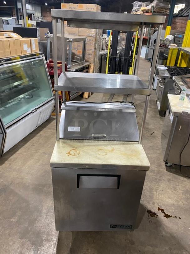 True TSSU-27-08 stainless steel refrigerated prep table with double shelf, cutting board, poly-coated wire rack, on casters.