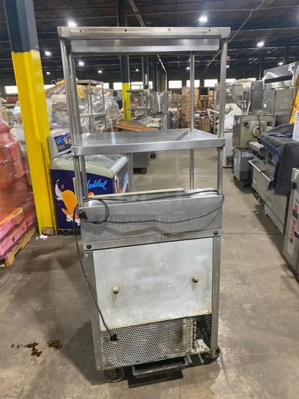 True TSSU-2708 stainless steel refrigerated prep table with double overhead shelf, cutting board, and wire rack.