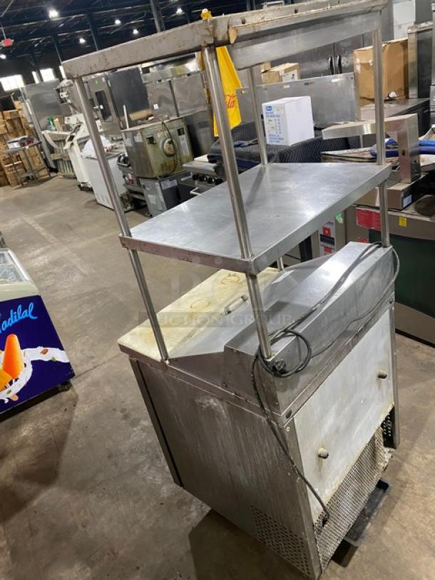 True stainless steel single door refrigerated prep table, Model TSSU-27-08, with cutting board, double shelves, on casters.