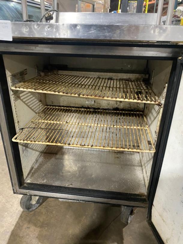 True TWT-27 stainless steel single door refrigerator with backsplash, double overhead shelf, poly coated wire racks, and casters.