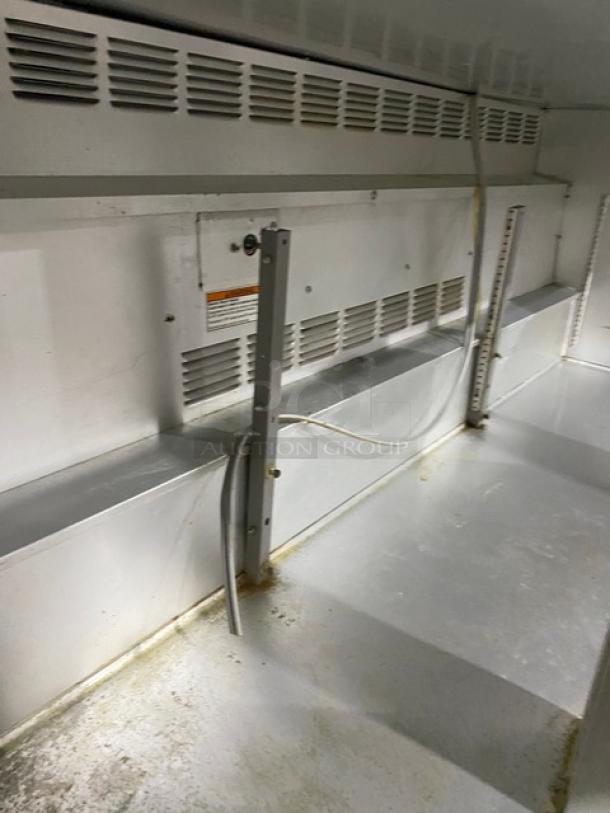 Interior view of Beverage-Air 3-door undercounter refrigerator, model UCR72A. Features stainless steel finish, poly-coated wire racks, and visible ventilation.