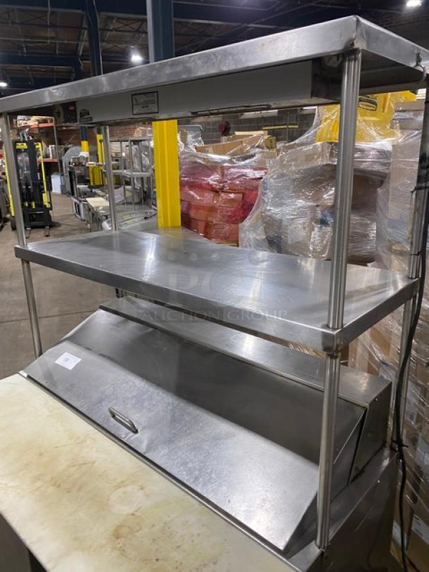 Stainless steel 2-door refrigerated salad/sandwich prep table with double overhead shelf, Hatco strip warmer, on casters.