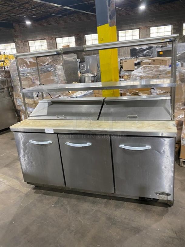 Kool-It KSP72 refrigerated prep table, stainless steel, 3 doors, with cutting board, double shelves, and casters.