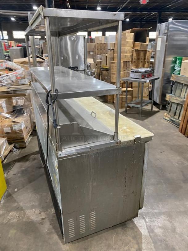 Kool-It KSP72 commercial stainless steel 3-door refrigerated prep table with cutting board, overhead shelf, and poly racks.