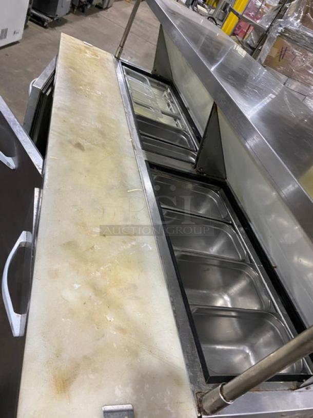 Kool-It 3-door refrigerated prep table, Model KSP72, stainless, with cutting board, double overhead shelf, wire racks, on casters.