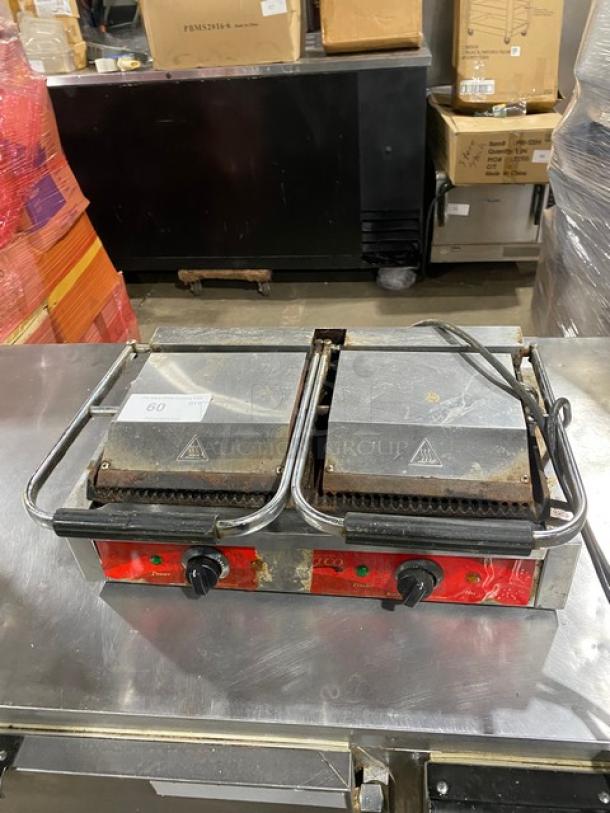 Avantco stainless steel dual panini grill with thermostatic control, grooved grates, on legs, used condition.
