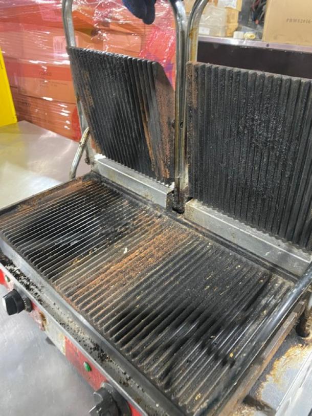 Avantco commercial stainless steel dual panini grill with thermostatic control, top & bottom grooved grates, in used condition.