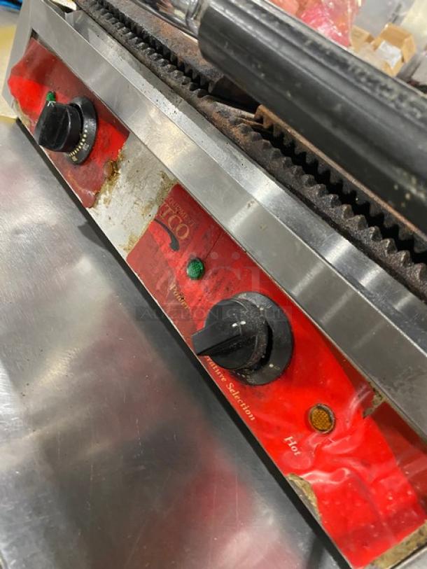 Avantco commercial stainless steel dual panini grill with thermostatic control, grooved grates, shown on legs.