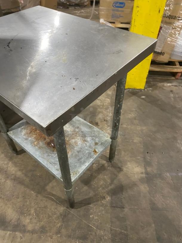 Aero commercial stainless steel worktop table with single undershelf, mounted on sturdy legs. Visible wear and scratches.