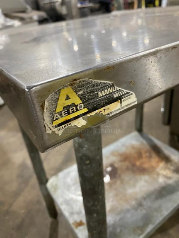 Aero stainless steel worktop table with single undershelf, visible wear, sturdy legs. Aero label shows manufacturer details.