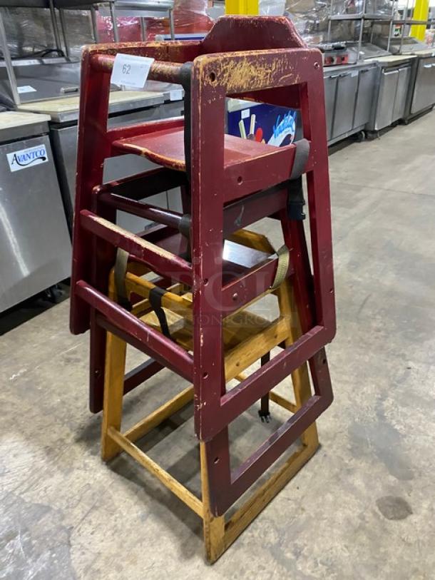 Stackable wooden highchairs with safety buckles, used condition, visible wear. Ideal for commercial use.