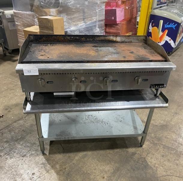 L&J JRMG-48 NG stainless steel gas griddle with undershelf stand, back & side splash, and gas hose. Exhibits signs of use.