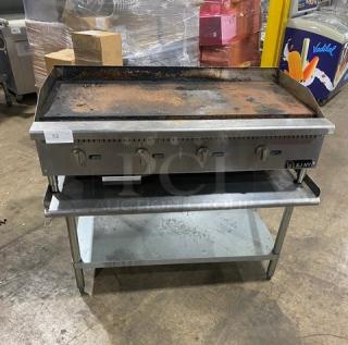 L&J JRMG-48 NG stainless steel gas griddle with undershelf stand, back & side splash, and gas hose. Exhibits signs of use.