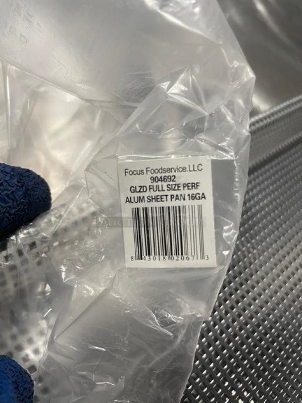 Brand new Focus Foodservice Model 904692 full-size perforated aluminum sheet pan, 16GA; tag indicates GLZD specification.