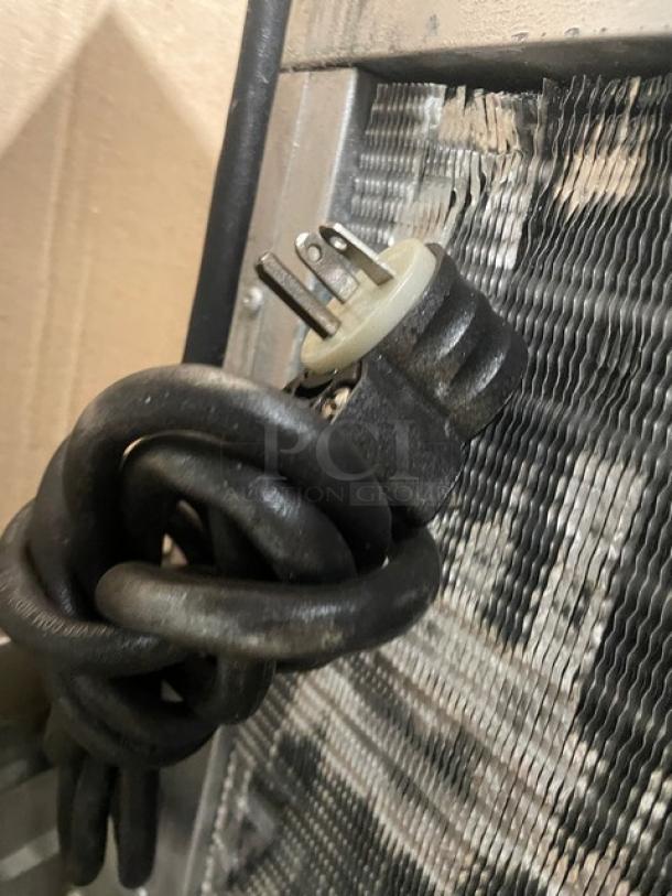Hoshizaki KM-515MAH ice maker power cord and plug, coiled, set against metal cooling fins. Air-cooled model, 115-120V, 1 phase.