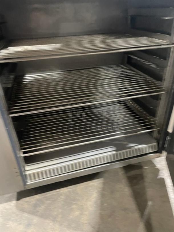FWE Commercial stainless steel countertop heated holding cabinet, model HLC-SL1826-8-CHP, with wired racks, on casters.