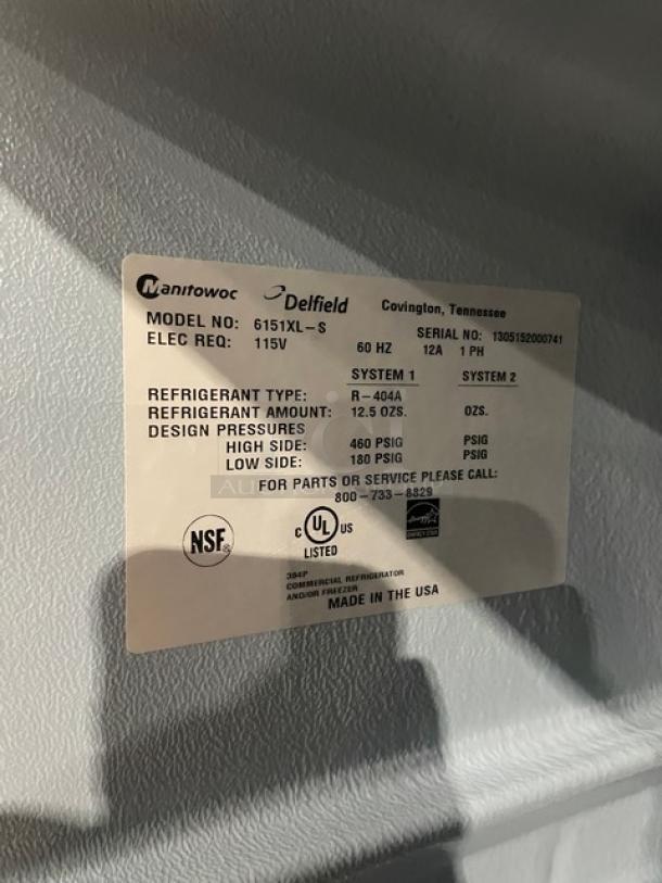 Delfield 6151XL-S commercial freezer label showing model, serial number, refrigerant details, and certifications.