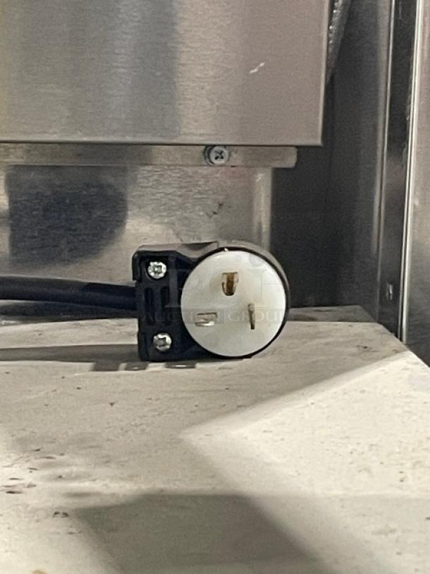 Delfield 6151XLS plug on a stainless steel surface, part of the commercial freezer. Features 115V 1 Phase compatibility.