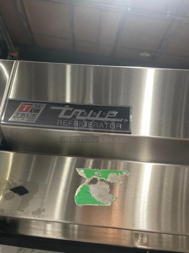 True T-49 commercial stainless steel 2-door reach-in refrigerator, poly-coated wire racks, on casters, scratched finish.
