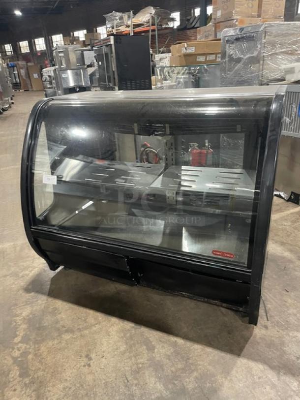 Tor-Rey 57" black curved glass refrigerated deli merchandiser, model TEM150NLUL, with stainless steel interior and adjustable shelves.