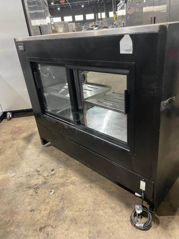 Tor-Rey commercial black 57" curved glass refrigerated deli display, Model TEM150NLUL, stainless interior, adjustable shelves.