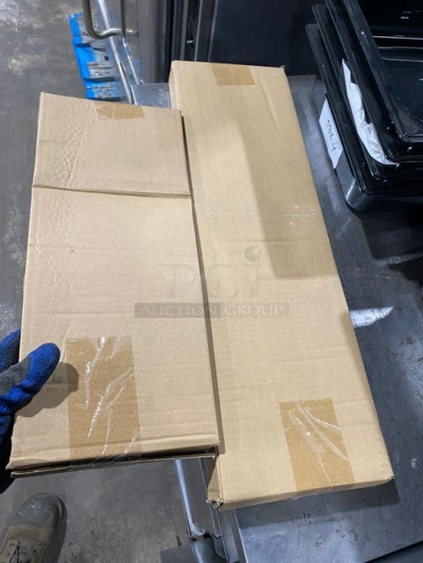 Prepline BAR1CLR underbar sink in packaging, showing two taped cardboard boxes on a metal surface.