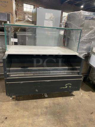 Commercial black multi-level refrigerated display case with glass showcase and legs. Used condition, ideal for grab-n-go products.