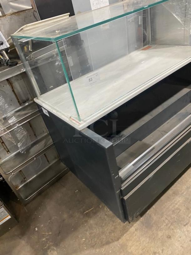 Commercial black multi-level refrigerated open grab-n-go merchandiser with enclosed glass showcase on legs; used condition.