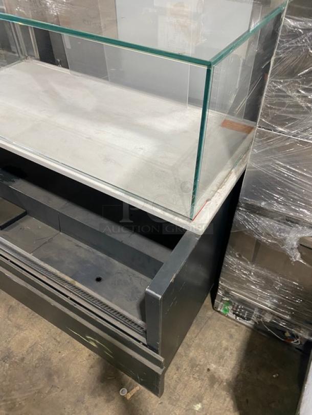 Starbucks-style black refrigerated display case with multi-level shelves, top enclosed glass showcase, and legs.