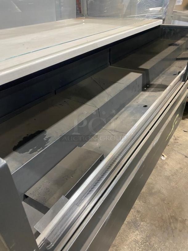 Commercial black multi-level refrigerated open grab-n-go merchandiser display case with top enclosed glass showcase, on legs.