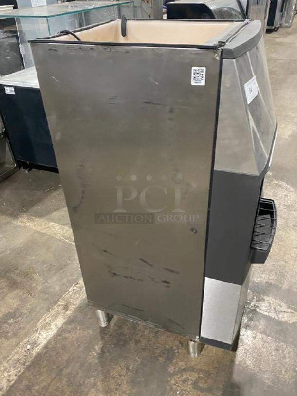 Manitowoc SPA160 stainless steel ice dispensing bin, 120 lb capacity, push dispenser, drip tray, on legs, good condition.
