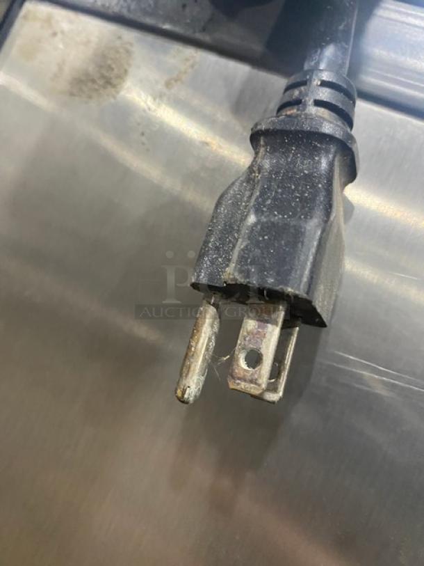 Manitowoc SPA160 ice dispensing bin plug detail; stainless steel, 120 lb capacity, push dispenser, drip tray, 115V, on legs.