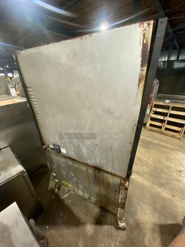 Cleveland Range stainless steel rotisserie convection oven, model BMR-32, natural gas, on casters, showing wear and rust.
