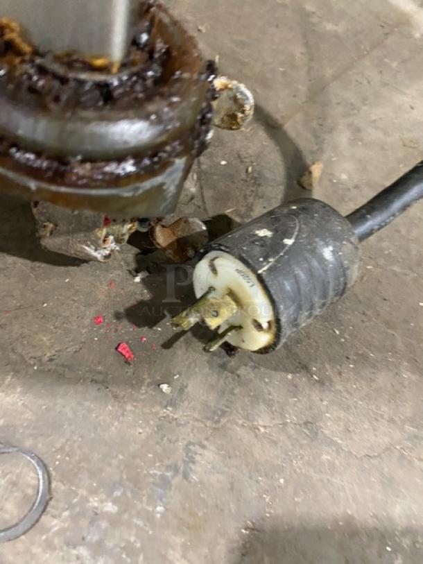 Cleveland Range BMR-32/BMW334 rotisserie oven power plug on dusty floor, highlighting electrical connection detail.