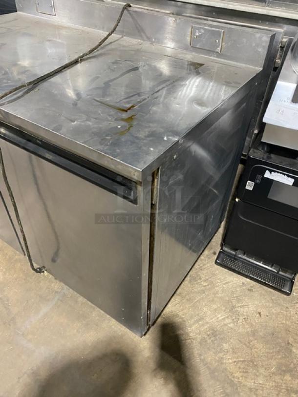Commercial stainless steel 2-door worktop table with backsplash, poly coated wire racks, on casters. Visible wear, for auction.