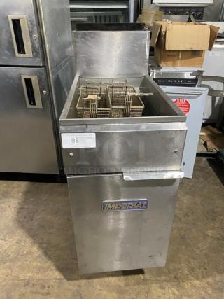 Imperial commercial stainless steel natural gas deep fat fryer with backsplash and fry baskets on legs. Visible logo.