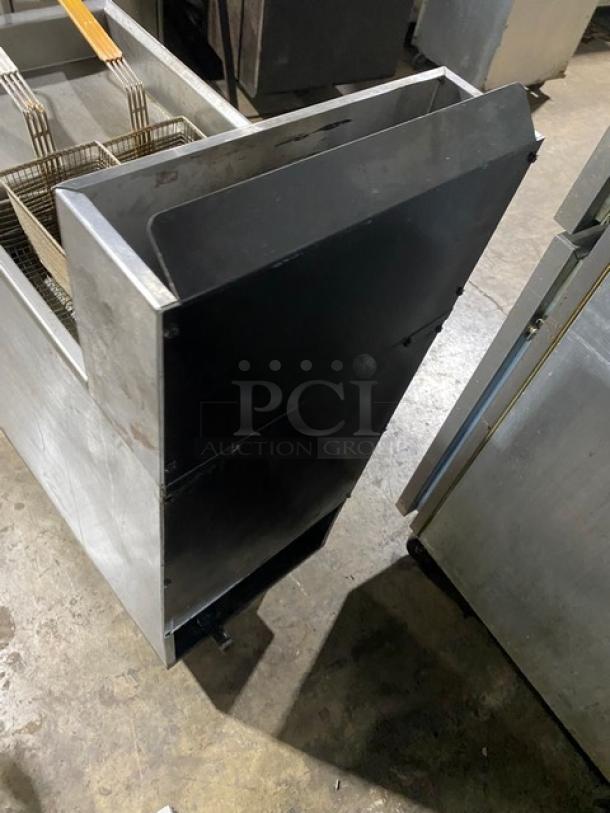 Imperial stainless steel natural gas deep fat fryer with back splash, fry baskets, on legs. Commercial kitchen equipment.